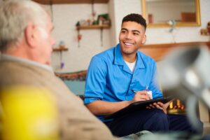 Photo of a nurse with a patient in a house setting.