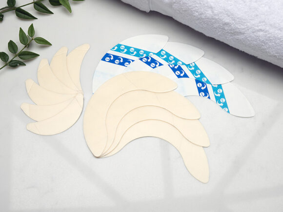 A selection of UltraFrame flange extenders fanned out on a marble countertop