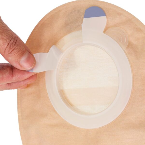 Aura 2 piece stoma pouch with a hand releasing the protective liner