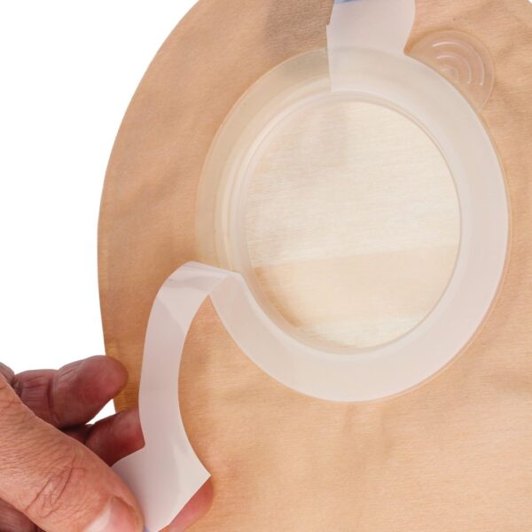 Aura 2 piece stoma pouch with a hand releasing the protective liner