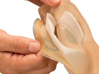 Aura Flushable with a hand showing the layers of the inside pouch