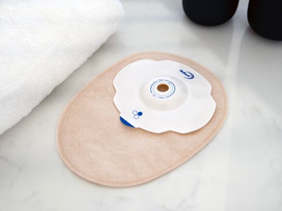 Aura Plus soft convex closed sand stoma bag with a towel.