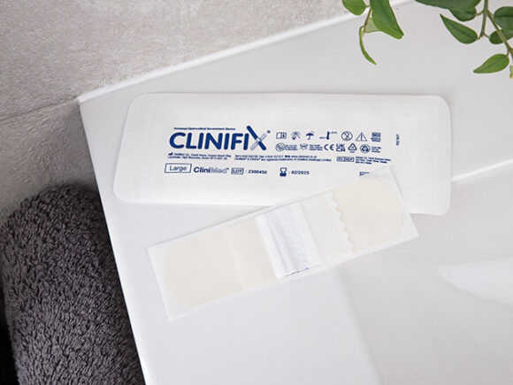 CliniFix tube holder with its packaging on the side of a sink.