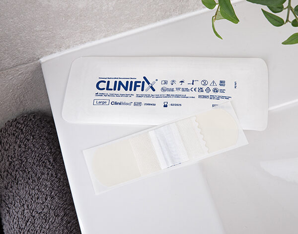 CliniFix tube holder with its packaging on the side of a sink.
