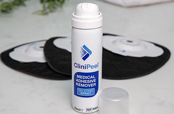 A can of CliniPeel with the lid off in front of black Aura Plus Soft Convex stoma bags