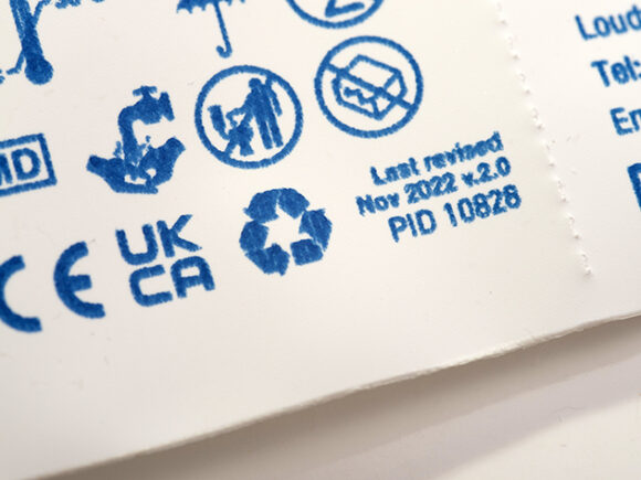 A close-up of the recycling information on CliniSure sheath packaging.