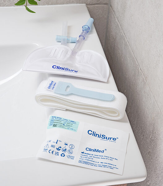 A CliniSure sheath package, a CliniSure retaining strap and a CliniSure leg bag on the side of a sink.