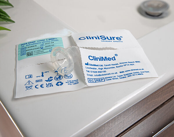 A CliniSure sheath sticking out of its packaging on the corner of a sink.