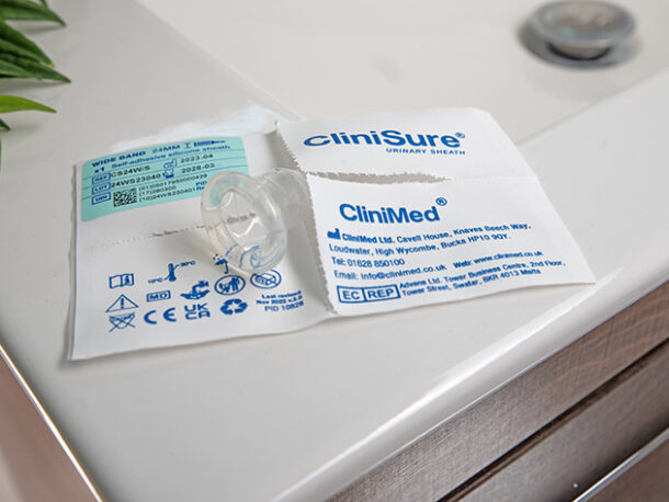 A CliniSure sheath sticking out of its packaging on the corner of a sink.