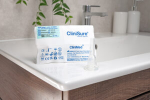 A CliniSure sheath next to its packaging on the corner of a sink.