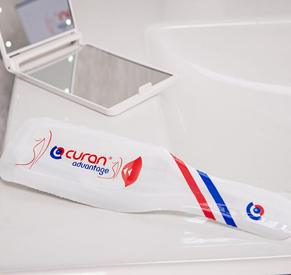 Curan advantage female catheter on a bathroom sink with a mirror and a towel.