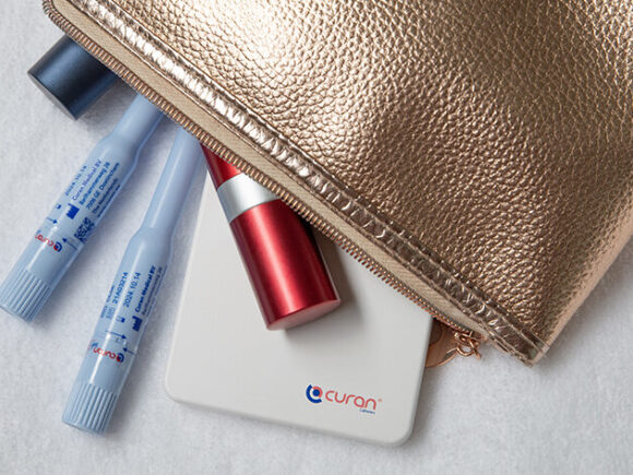 Curan lady in a gold make up bag with lipsticks.