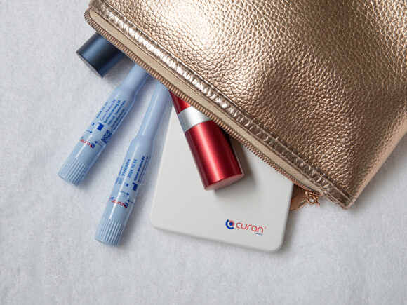 Curan lady in a gold make up bag with lipsticks.