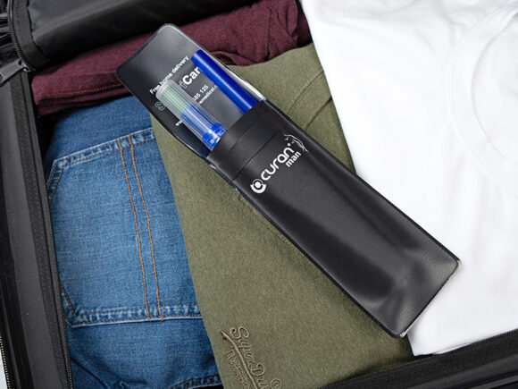 Curan man in a Curan wallet in a suitcase full of clothes.