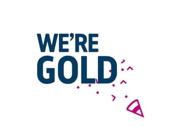 Image with text written in blue: We're gold and pink confetti