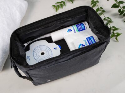 Aura Plus soft convex closed black in a bag with CliniPeel Mint Medical Adhesive Remover spray and CliniPeel wipes.