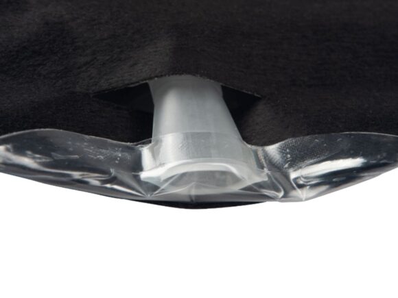 The tap of a black Aura Plus urostomy bag folded away