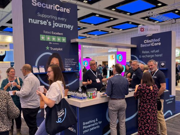 Photo of our booth and attendees at ASCN 2025.