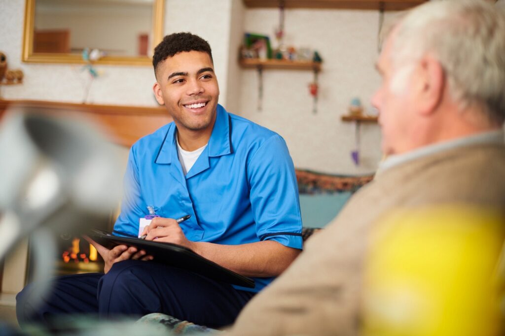 Photo of a nurse with a patient in a house setting.