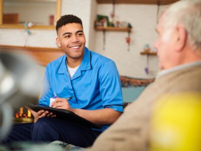 Photo of a nurse with a patient in a house setting.