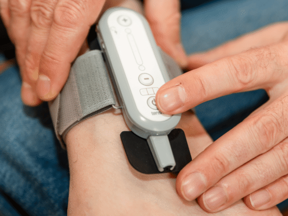 Photo of a person wearing Tensi+ on their ankle.