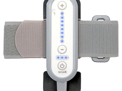 Tensi+ device showing the front controls of the unit and the comfortable, elasticated leg strap with lights showing.