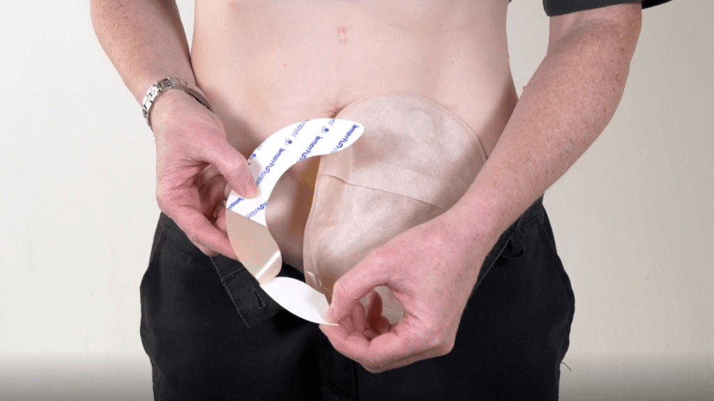 Photo of a lady standing up peeling back the liner from a HydroFrame Flange Extender.