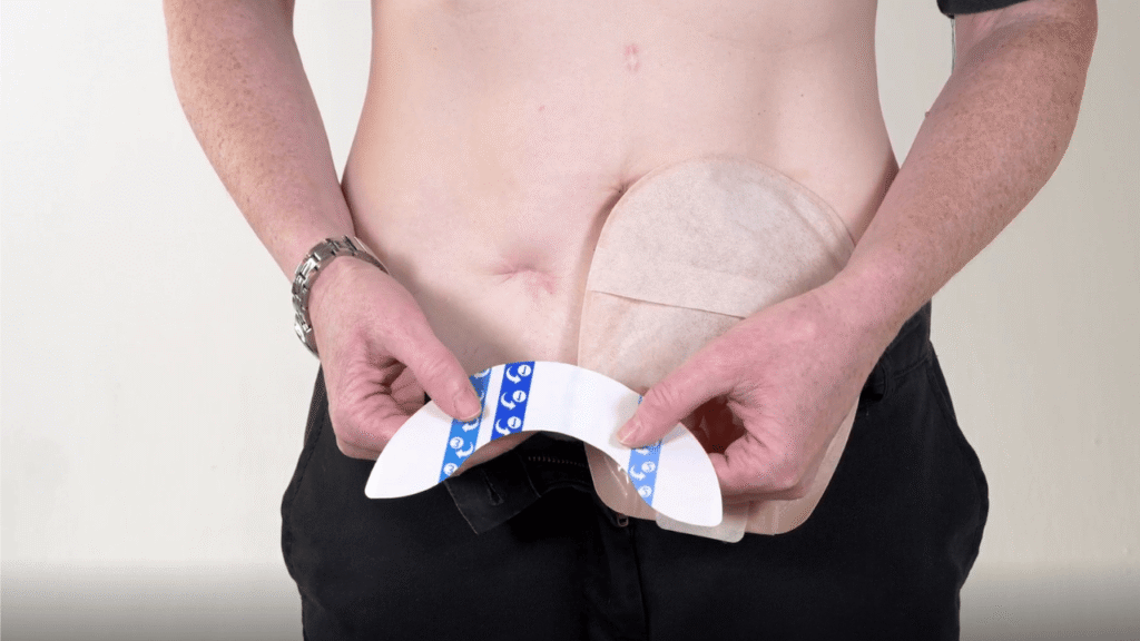 Photo of a lady standing up holding an UltraFrame Flange Extender.