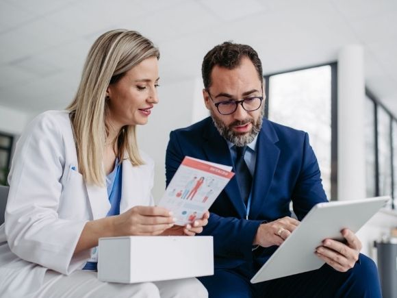 Product specialist talking to a clinician on a ward