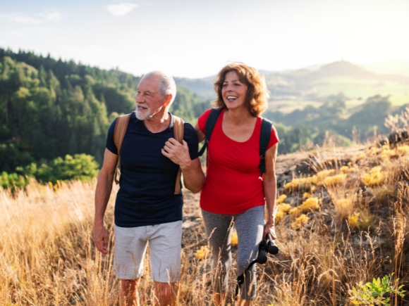 Photo of a man and woman hiking together in a field