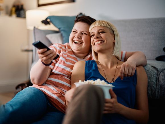 Photo of two women watching TV together