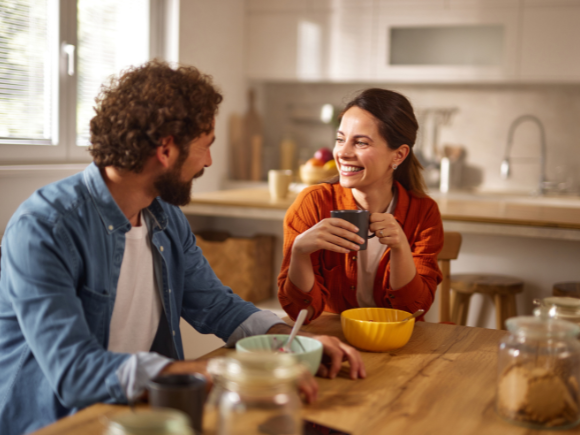 Photo of a man and woman eating breakfast together