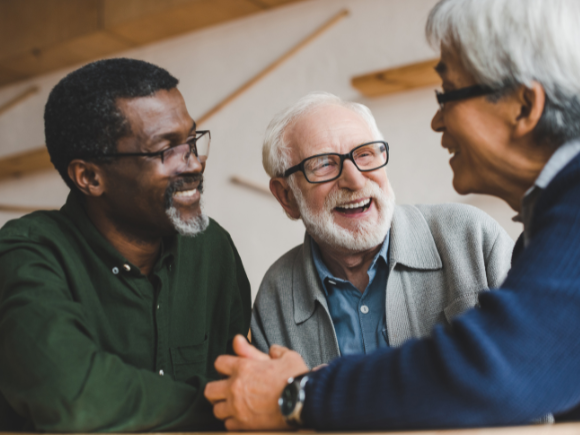 Image of three elderly male friends talking together