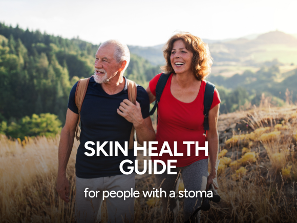 Image of a man and woman walking through a field together alongside text 'skin health guide for people with a stoma'