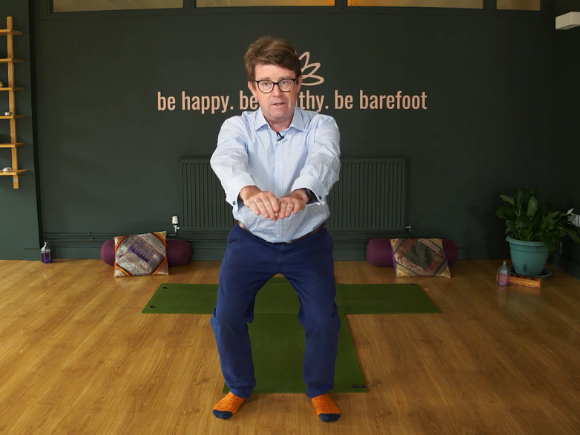 Photo of Gerard Greene, specialist physiotherapist, performing a standing pelvic floor exercise