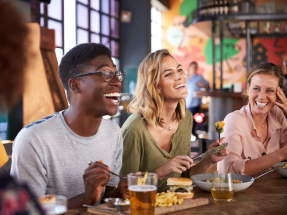 Photo of a group of friends eating together at a resturaunt