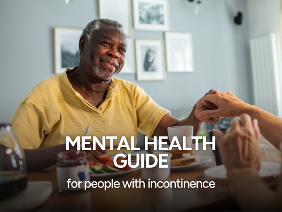 A man and woman sat the table holding hands with text 'Mental health guide for people with incontinence'