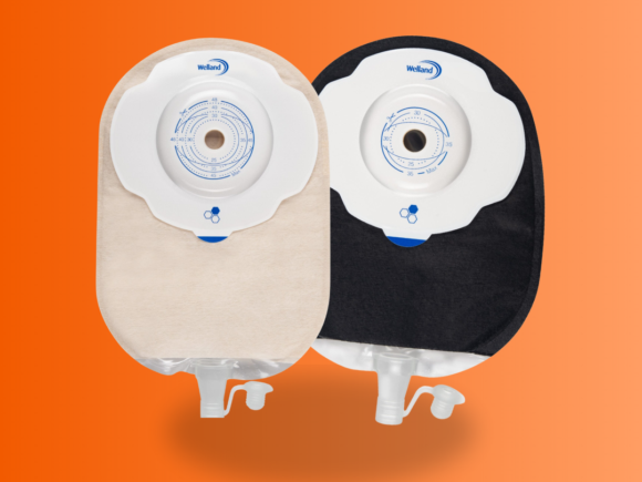 Aura Plus urostomy pouch in sand and black on an orange background