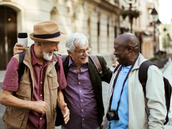 Image of three male friends exploring a city