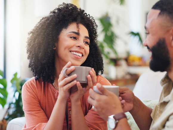 Photo of a man and woman sitting together drinking coffee